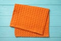 Orange kitchen towel on blue wooden table