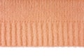 Orange knitted woolen jersey fabric, sweater texture with edge isolated on white background Royalty Free Stock Photo