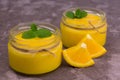 Orange Kurd in low jars. Orange summer, refreshing dessert. Close-up.