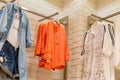 Orange lady shirt hanged on the racks