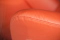 Orange leather sofa armrest