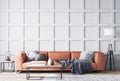 Orange leather sofa in Scandinavian living room with gray wooden wall paneling, home decor Royalty Free Stock Photo