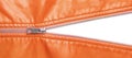 Orange leather texture and open metal zipper isolated on white background Royalty Free Stock Photo