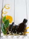 Orange, leaves and brown bottles with essential oil on wooden table Royalty Free Stock Photo