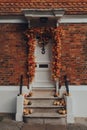 Orange leaves and pumpkins Halloween decorations by the entrance to house in Rye, UK