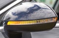 Orange LED turn signal in the mirror of a modern car, close-up Royalty Free Stock Photo