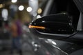 Orange LED turn signal in the mirror of a modern car, close-up. Transportation Royalty Free Stock Photo