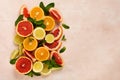 Orange, lemon, grapefruit, mandarin and lime on trendy pink stone or concrete table background. Citrus fruits. Royalty Free Stock Photo