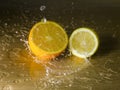 Orange and lemon on wooden surface with waterdrops Royalty Free Stock Photo