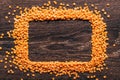 Orange lentils nicely laid out on a wooden background. Top view. rectangular copy space. Vegetarian food. Unprepared