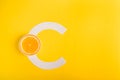 Orange and letter C on a yellow background. The concept of Vitamin S. Autumn protection against colds, antioxidant