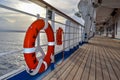 Atlantic Ocean - March 29 2014: Orange life buoy on deck of the Carnival Liberty cruise ship. Royalty Free Stock Photo