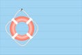 Orange life buoy hanging on blue wooden wall, SOS and rescue concept, copy space Royalty Free Stock Photo