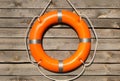 Orange life buoy hanging on wooden wall Royalty Free Stock Photo