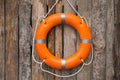 Orange life buoy hanging on wooden wall Royalty Free Stock Photo