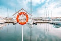 Orange life buoy on the pier by the sea Royalty Free Stock Photo