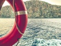 Orange life buoy on the ship. cruise. to save passengers, an air circle made of rubber hangs. rescue equipment under an awning Royalty Free Stock Photo