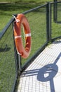 Orange life guard ring at the swimming pool. Royalty Free Stock Photo