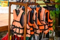 Orange life jackets hanging on rack Royalty Free Stock Photo