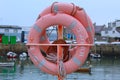 Orange life ring in harbour