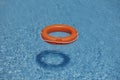 Orange life rings in blue water Royalty Free Stock Photo