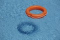 Orange life rings in blue water Royalty Free Stock Photo