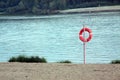 Orange life saver on the beach near the river Royalty Free Stock Photo