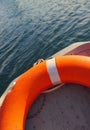 Orange lifebelt lying in boat