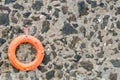 An orange lifebelt on a old stone wall Royalty Free Stock Photo