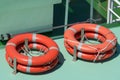 Orange lifebuoy at the boat, lifeguard float. Lifeguard equipment, life saver or life ring. Concept of vacation and safety when Royalty Free Stock Photo