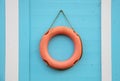 Orange lifebuoy hanging on a wall Royalty Free Stock Photo