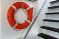 Orange lifebuoy hanging on the wall at the exit Royalty Free Stock Photo