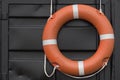 Orange lifebuoy hanging on the wall Royalty Free Stock Photo