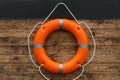 Orange lifebuoy hanging on wall. Rescue equipment Royalty Free Stock Photo