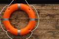 Orange lifebuoy hanging on wall, space for text. Rescue equipment Royalty Free Stock Photo