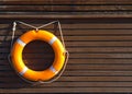 Orange lifebuoy hanging wooden wall Royalty Free Stock Photo