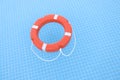 Orange lifebuoy lying on water in swimming pool closeup Royalty Free Stock Photo