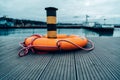 Orange lifebuoy on the pier in the port in the evening Royalty Free Stock Photo