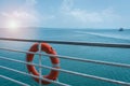 Orange lifebuoy ring hanging on ferry boat with ocean backgroun