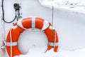 Orange lifebuoy ring on white boat in winter Royalty Free Stock Photo