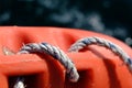 Orange lifebuoy on the sea background. Lifeline hanging on the pier. Rescue boat on the sea Royalty Free Stock Photo