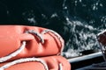 Orange lifebuoy on the sea background. Lifeline hanging on the pier. Rescue boat on the sea Royalty Free Stock Photo