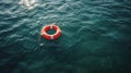 Orange lifebuoy on the water in the blue sea. Safety on the water, rescue of a drowning person