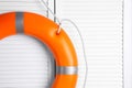 Orange lifebuoy on white wooden background, space for text. Rescue equipment Royalty Free Stock Photo