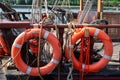 orange lifebuoys on old sailboat