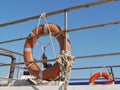 Orange lifebuoys opposite a blue sky