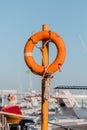 Orange lifeguard ring on a metallic pole