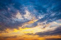 Orange light and dark clouds on sky before sunset. Royalty Free Stock Photo