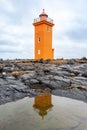 Orange lighthouse and his mirroring