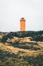 Orange Lighthouse Svortuloft Skalasnagi tower in Snaefellsnes Peninsula, west Iceland on an overcast day.